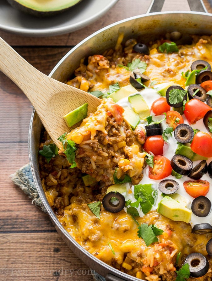 spoonful of ground beef rice mixture in pan with spoon