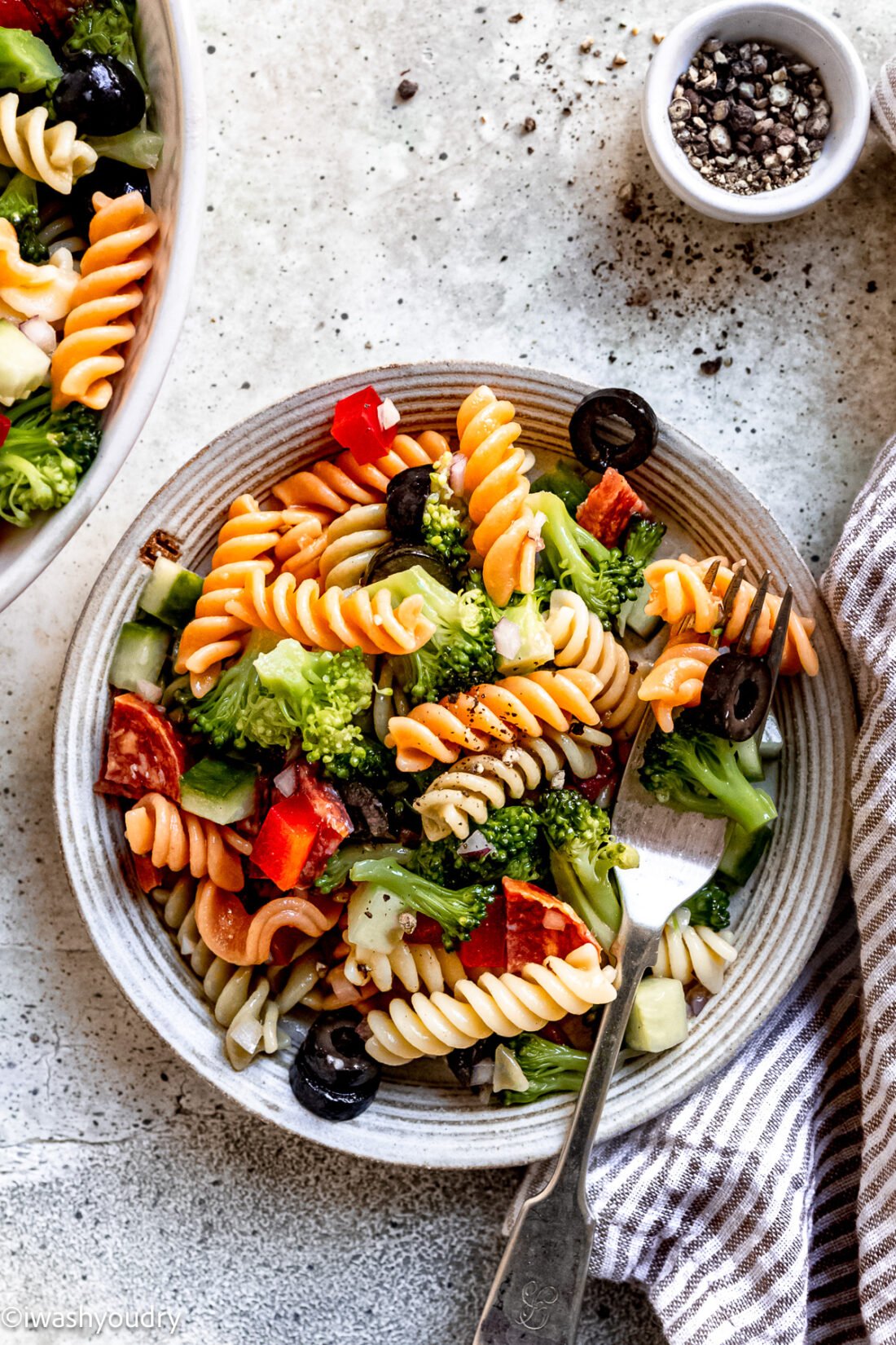 plateful of pasta salad with broccoli, olives and pepperoni.