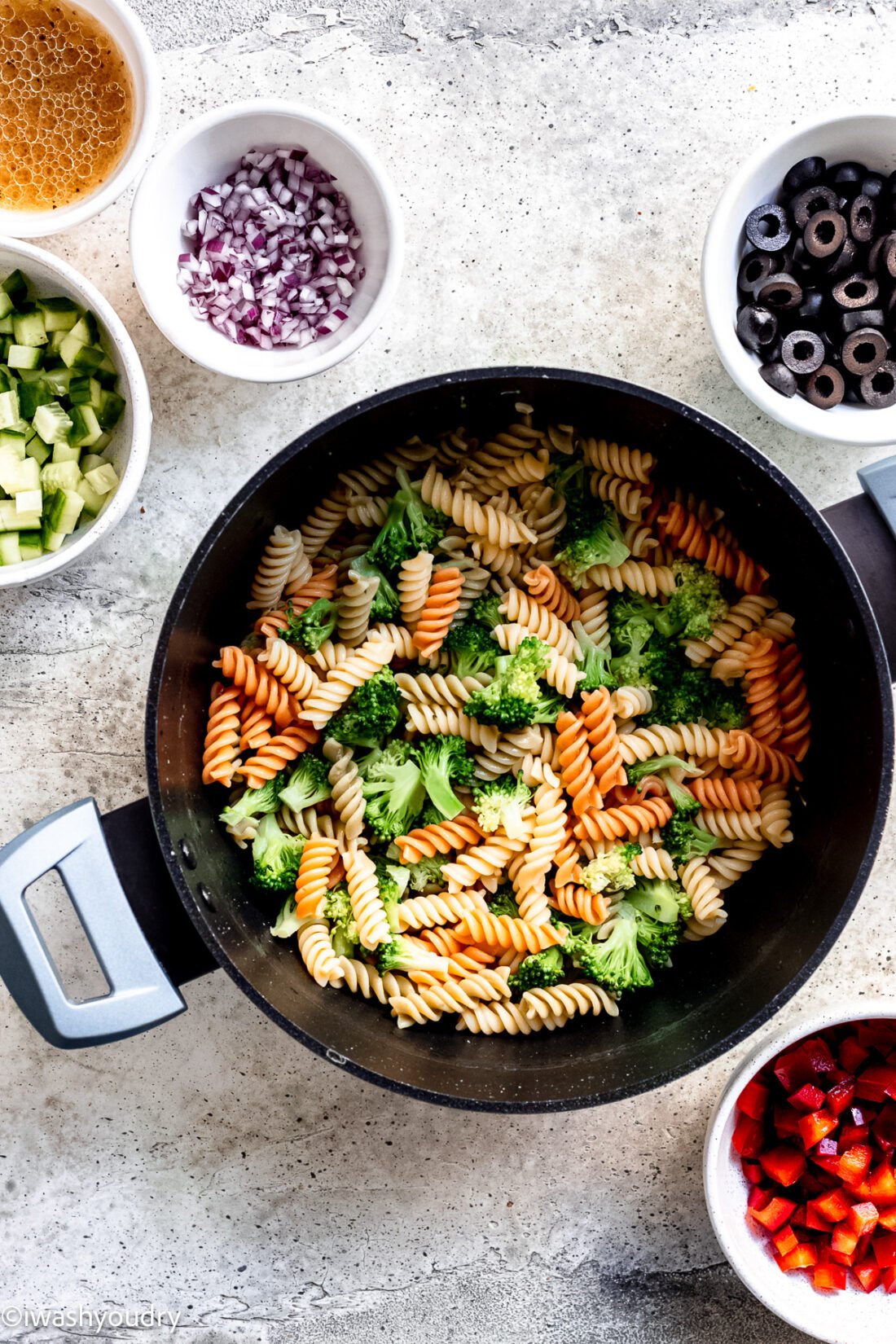 stainer filled with cooked pasta and broccoli.