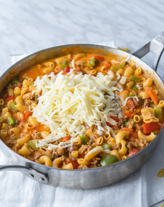 This Cheesy Sausage and Macaroni Skillet dinner recipe is super quick and easy, perfect for busy weeknights!