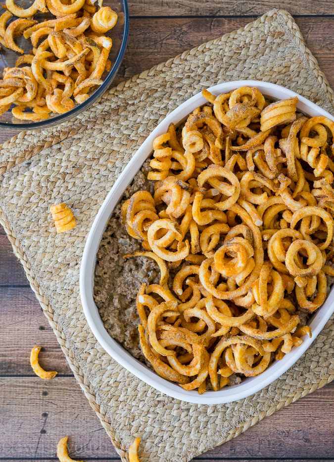 This Cheeseburger and French Fry Casserole is filled with all the hamburger favorites and even topped with crispy seasoned french fries and a creamy fry sauce!