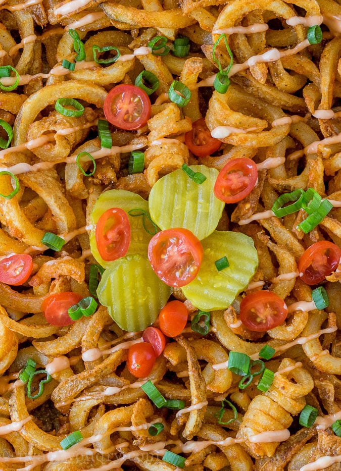 This Cheeseburger and French Fry Casserole is filled with all the hamburger favorites and even topped with crispy seasoned french fries and a creamy fry sauce!