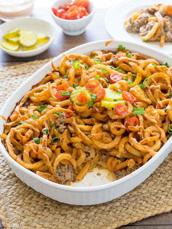 This Cheeseburger and French Fry Casserole is filled with all the hamburger favorites and even topped with crispy seasoned french fries and a creamy fry sauce!