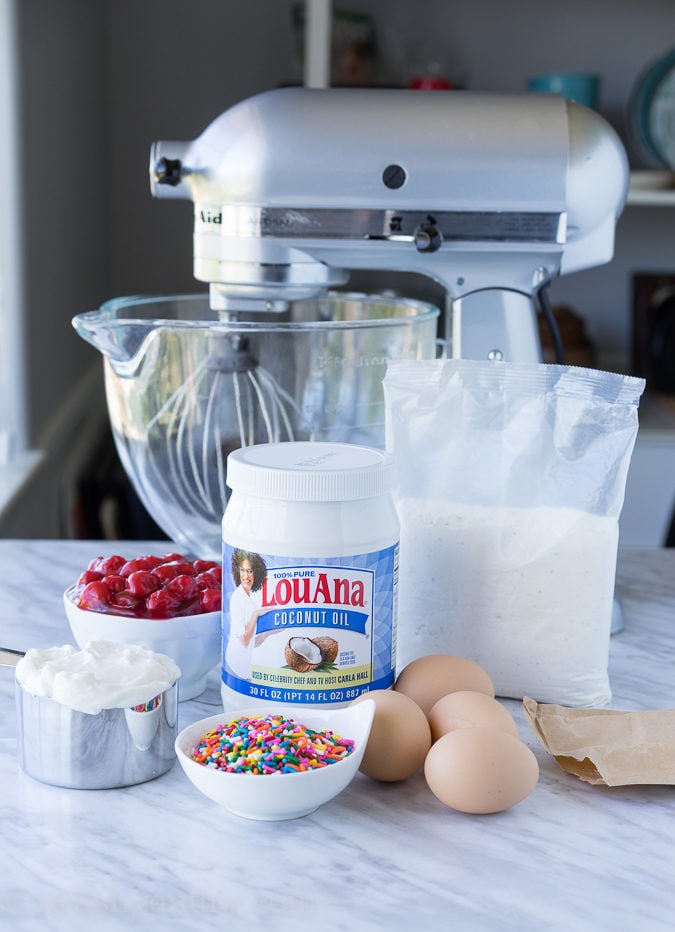 This Cherry Surprise Cake is a moist funfetti cake that's filled with cherry pie filling! So fun and so delicious, my whole family loved it!