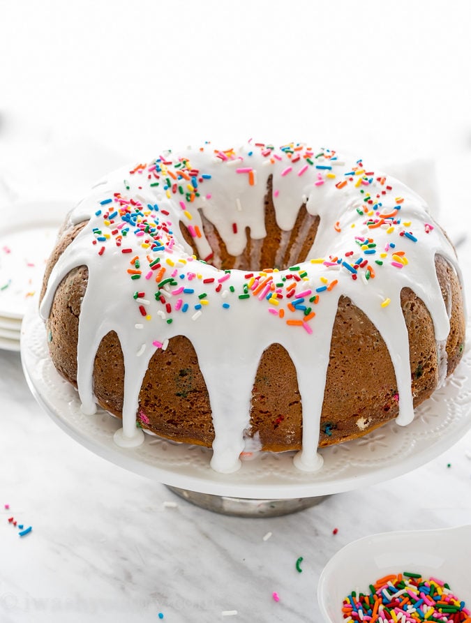 This Cherry Surprise Cake is a moist funfetti cake that's filled with cherry pie filling! So fun and so delicious, my whole family loved it!