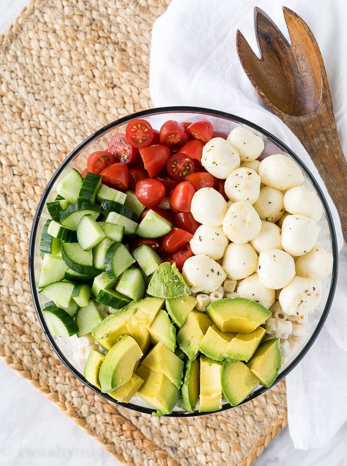 This Avocado Caprese Pasta Salad is a cold pasta salad that is perfect for parties and bbq's! Full of fresh veggies and creamy pasta!