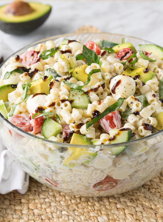 This Avocado Caprese Pasta Salad is a cold pasta salad that is perfect for parties and bbq's! Full of fresh veggies and creamy pasta!