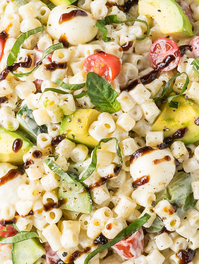 This Avocado Caprese Pasta Salad is a cold pasta salad that is perfect for parties and bbq's! Full of fresh veggies and creamy pasta!