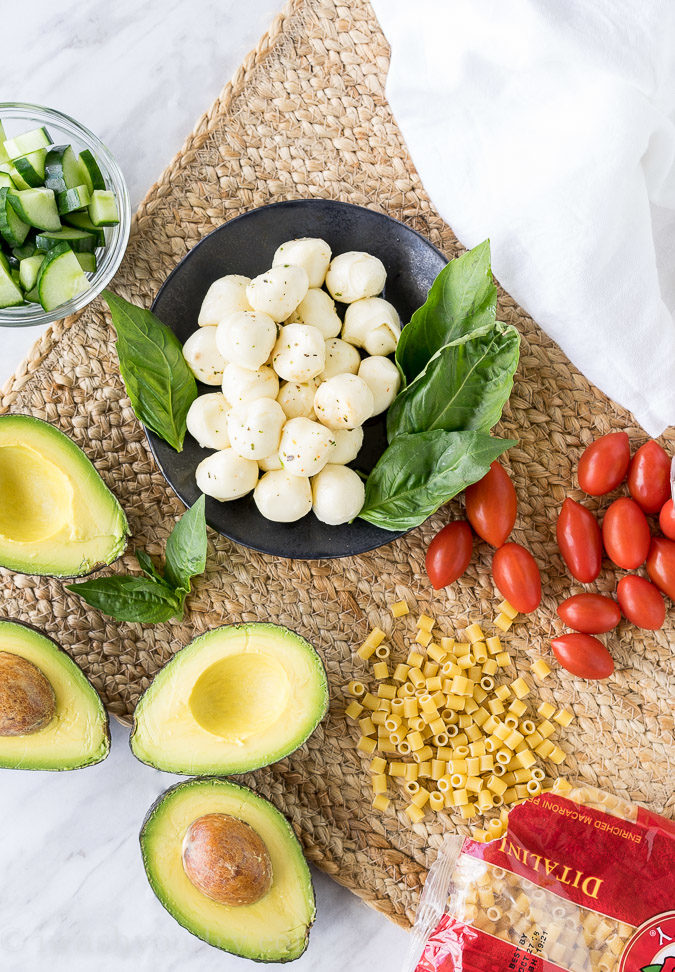 This Avocado Caprese Pasta Salad is a cold pasta salad that is perfect for parties and bbq's! Full of fresh veggies and creamy pasta!