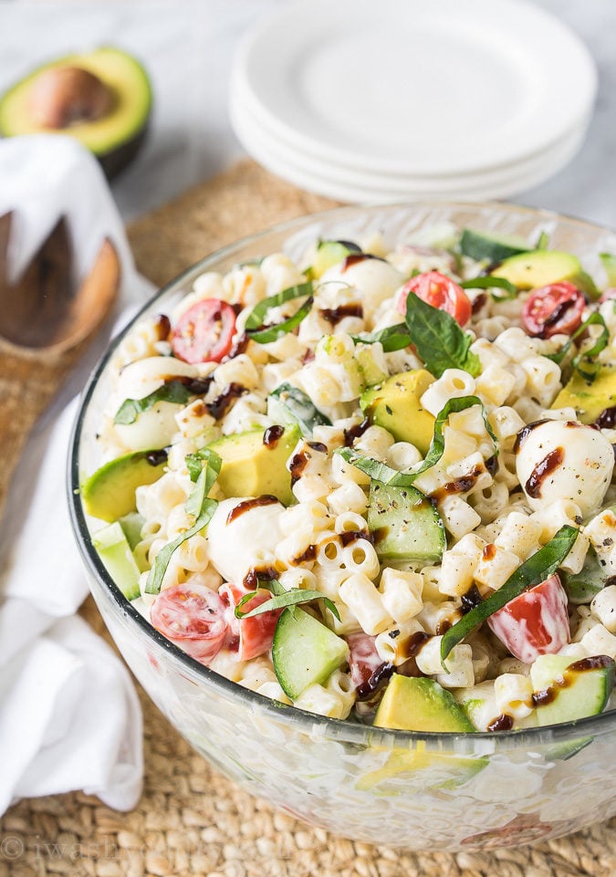 This Avocado Caprese Pasta Salad is a cold pasta salad that is perfect for parties and bbq's! Full of fresh veggies and creamy pasta!