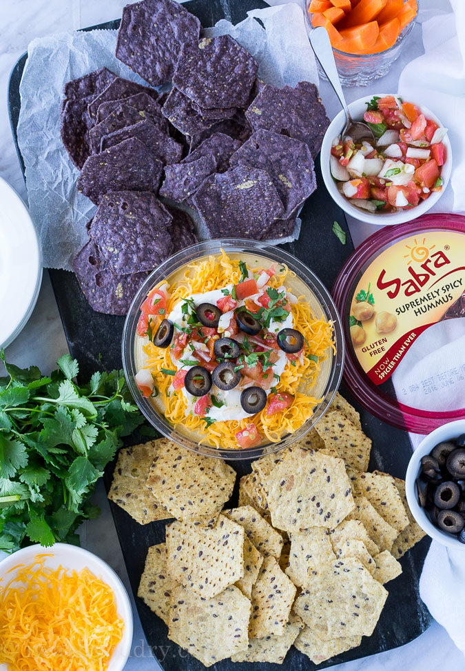 This is by far the easiest way to have your #unofficialmeal. This easy Mexican Layered Hummus Dip starts with a tub of Sabra hummus and is piled high with all the classic taco fillings! So good!