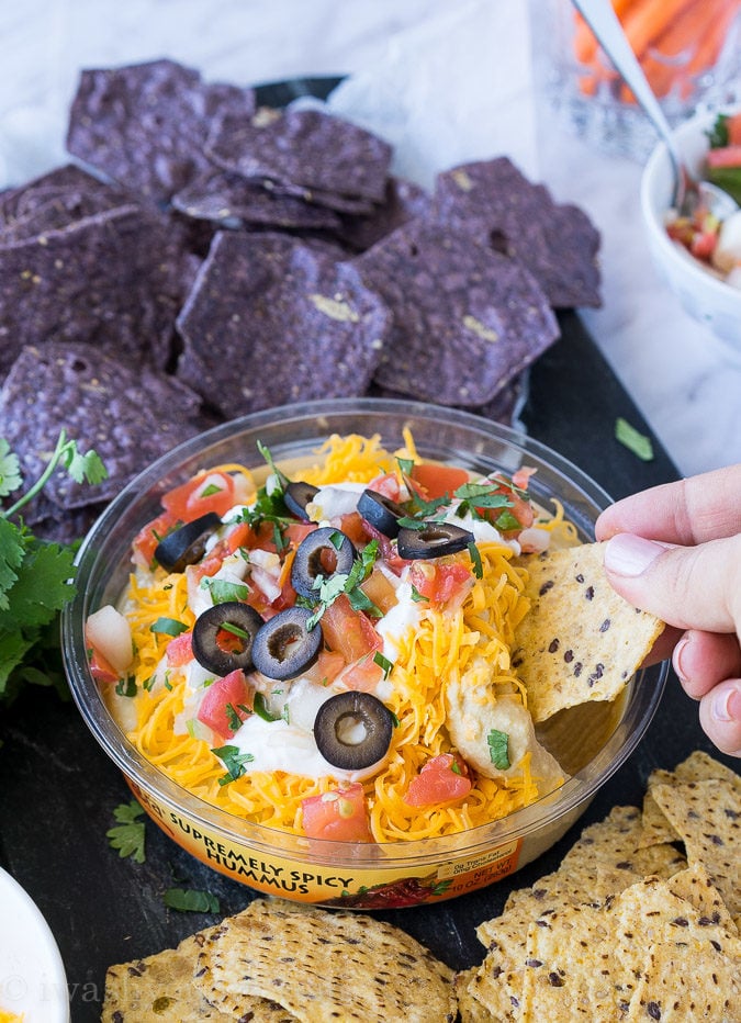 This is by far the easiest way to have your #unofficialmeal. This easy Mexican Layered Hummus Dip starts with a tub of Sabra hummus and is piled high with all the classic taco fillings! So good!