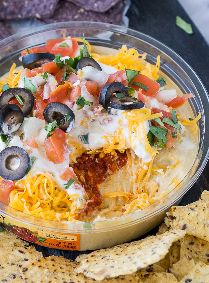 This is by far the easiest way to have your #unofficialmeal. This easy Mexican Layered Hummus Dip starts with a tub of Sabra hummus and is piled high with all the classic taco fillings! So good!
