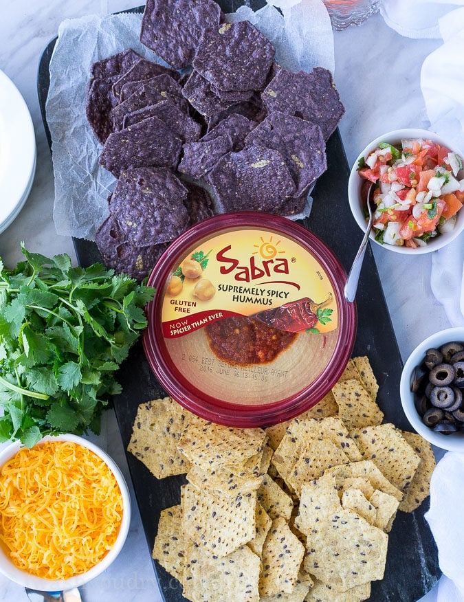 This is by far the easiest way to have your #unofficialmeal. This easy Mexican Layered Hummus Dip starts with a tub of Sabra hummus and is piled high with all the classic taco fillings! So good!