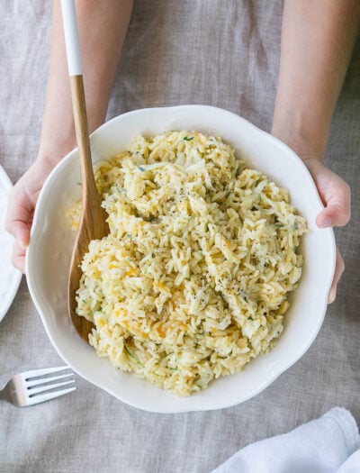 I love making this 5 minute Cheesy Zucchini Rice recipe for a quick and easy side dish! Even my kids get in there and help too!