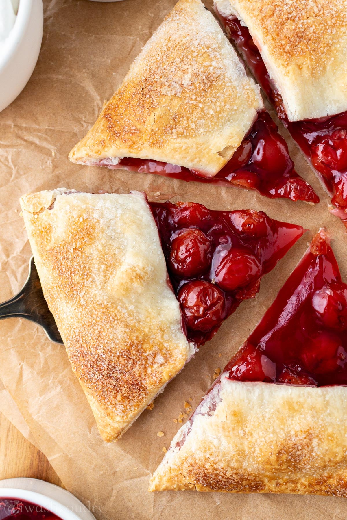 sliced cherry galette on serving spoon.