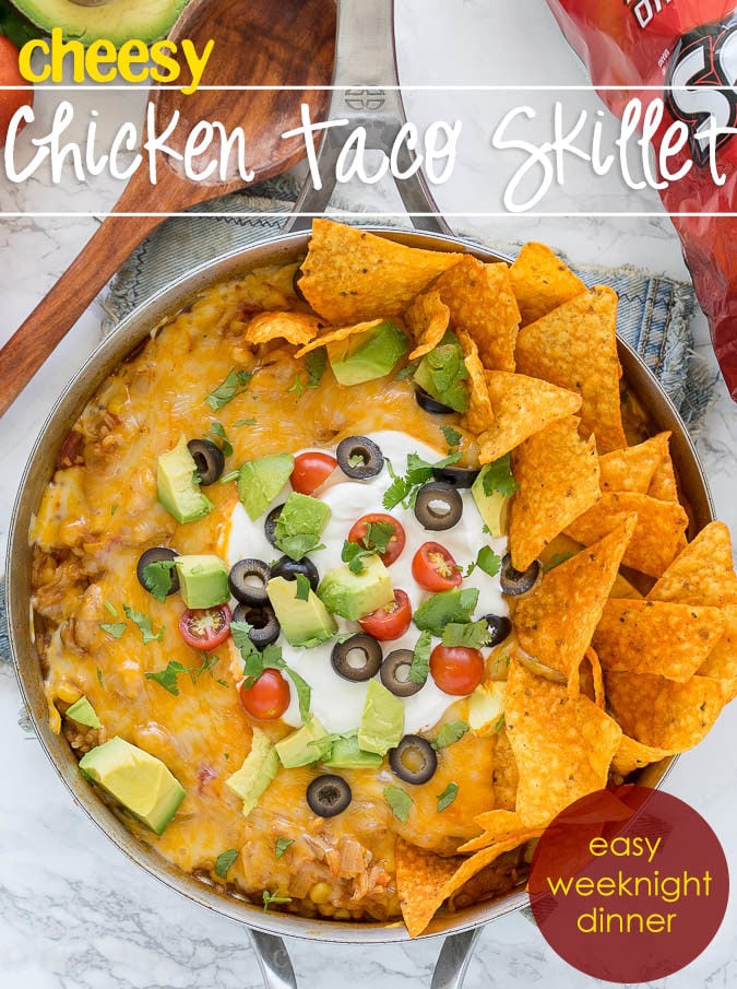 This one pan, Mexican Chicken Taco Skillet is filled with chicken, rice and corn, then topped with all the yummy taco fixin's for a delicious dinner recipe that my family requests over and over again!