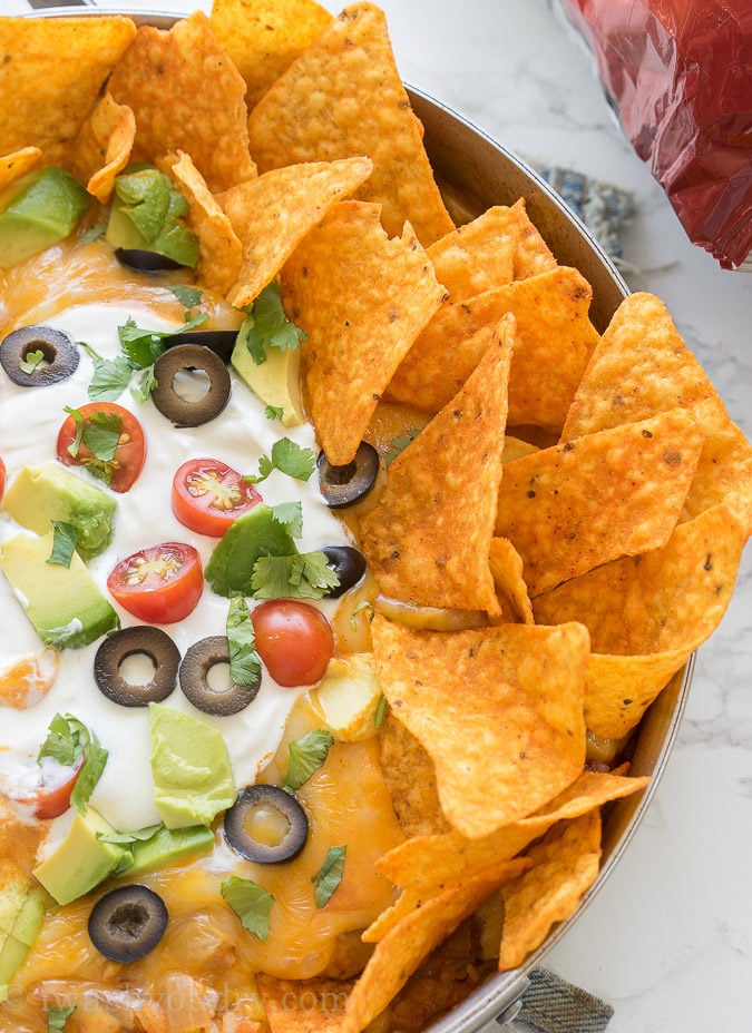 This one pan, Mexican Chicken Taco Skillet is filled with chicken, rice and corn, then topped with all the yummy taco fixin's for a delicious dinner recipe that my family requests over and over again!