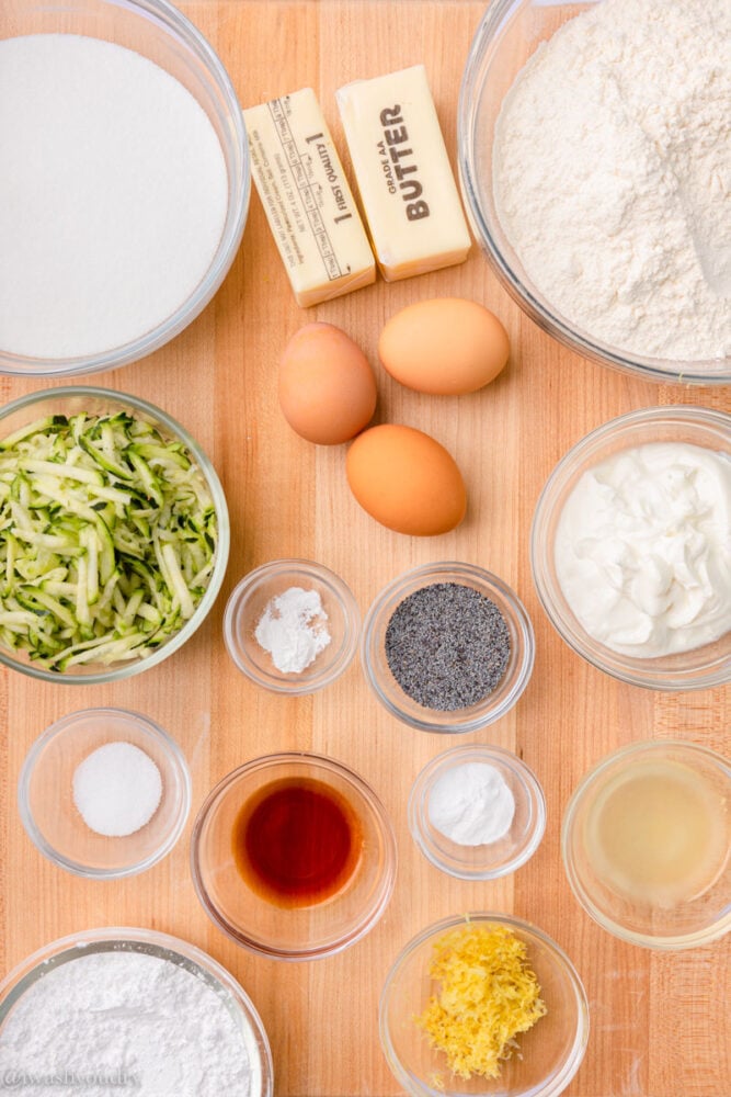 ingredients for zucchini bread on wooden surface.