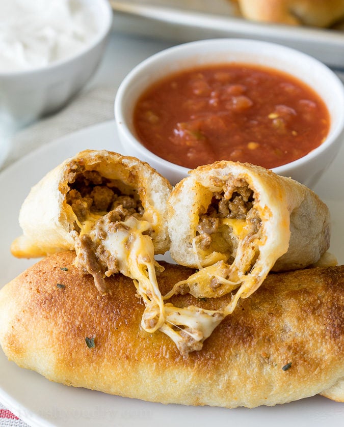 These super simple Cheesy Taco Sticks are buttery breadsticks filled with taco meat and lots of cheese! Perfect for snacking or watching the big game!