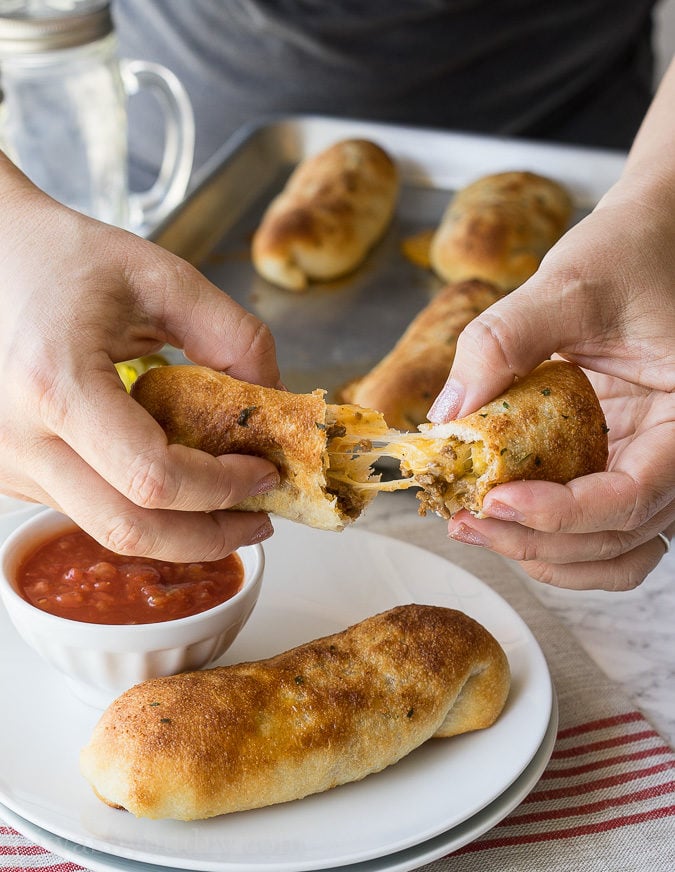 These super simple Cheesy Taco Sticks are buttery breadsticks filled with taco meat and lots of cheese! Perfect for snacking or watching the big game!