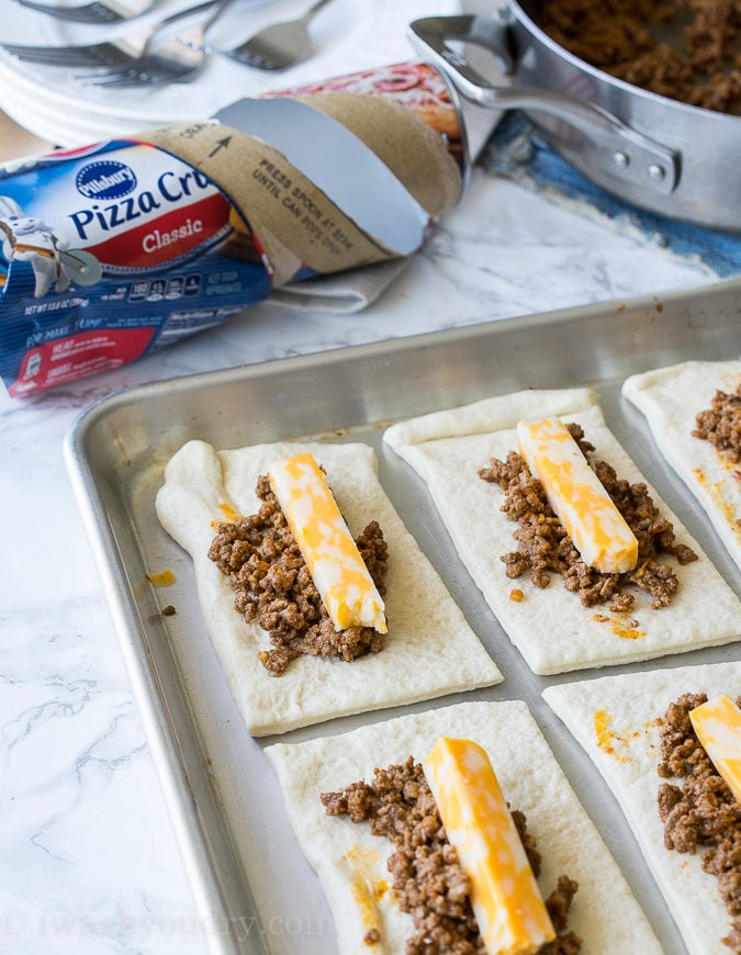 These super simple Cheesy Taco Sticks are buttery breadsticks filled with taco meat and lots of cheese! Perfect for snacking or watching the big game!