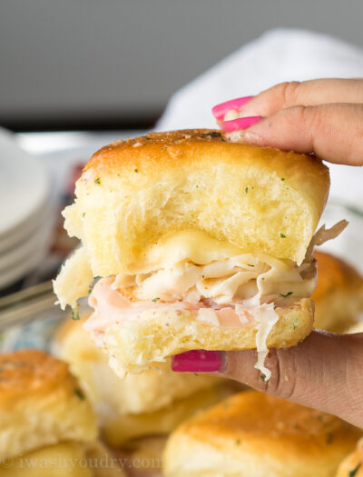 These Buttery Chicken Cordon Bleu Sliders have layers of swiss cheese, thinly sliced deli ham and chicken with an irresistible honey mustard sauce on buttery soft roll, then baked till hot and extra gooey.