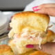 These Buttery Chicken Cordon Bleu Sliders have layers of swiss cheese, thinly sliced deli ham and chicken with an irresistible honey mustard sauce on buttery soft roll, then baked till hot and extra gooey.