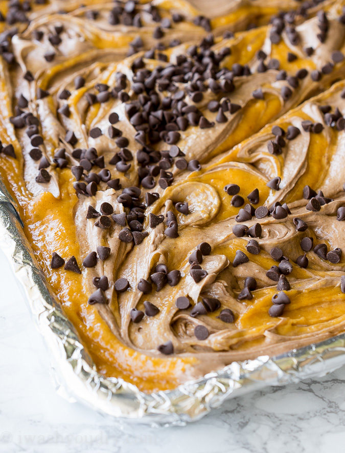 These Chocolate Swirled Pumpkin Bars are made on a large baking sheet, which make them perfect for taking to pot lucks and parties this Fall! I love that chocolate cheesecake swirled throughout too!