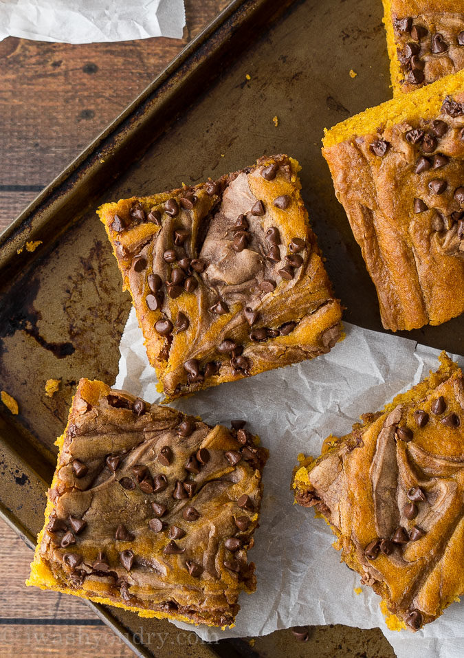 These Chocolate Swirled Pumpkin Bars are made on a large baking sheet, which make them perfect for taking to pot lucks and parties this Fall! I love that chocolate cheesecake swirled throughout too!