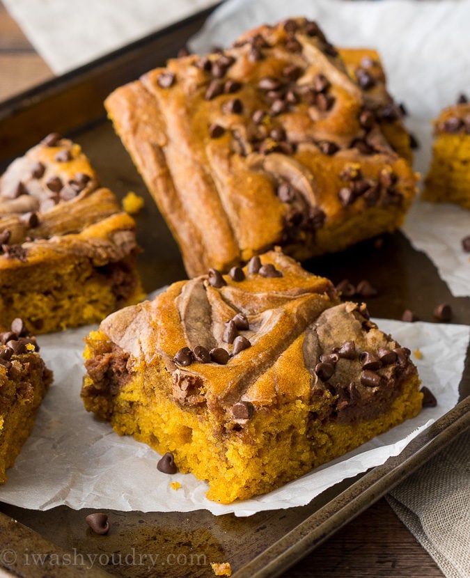 These Chocolate Swirled Pumpkin Bars are made on a large baking sheet, which make them perfect for taking to pot lucks and parties this Fall! I love that chocolate cheesecake swirled throughout too!