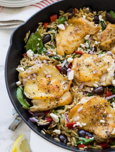 This Greek Chicken Skillet is a one pan meal that's full of bold flavors and made super quick! You'll love this recipe!