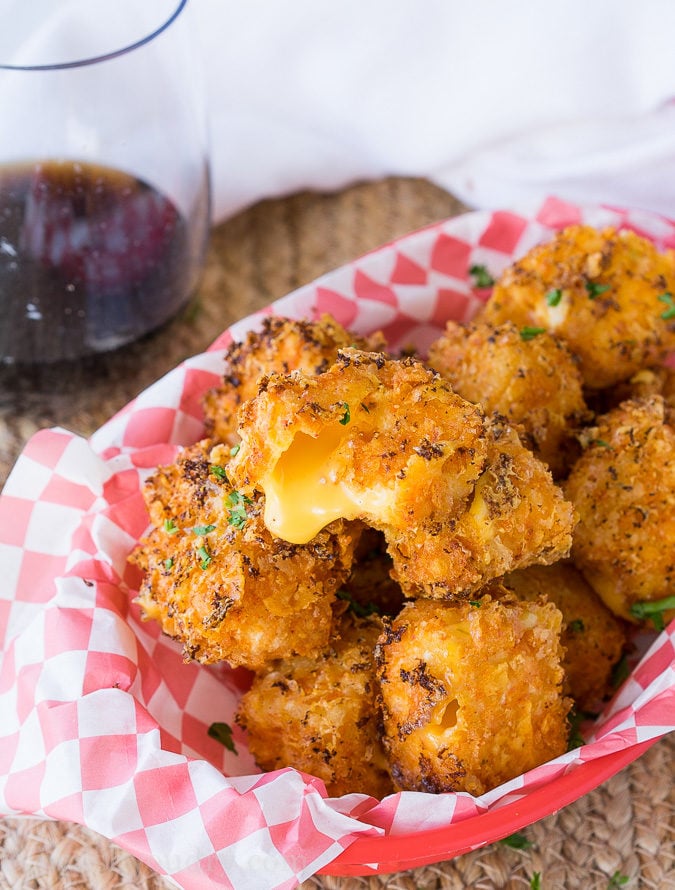 OMG! These Crispy Queso Bites are coated in nacho cheese doritos and then fried to gooey cheesy perfection!