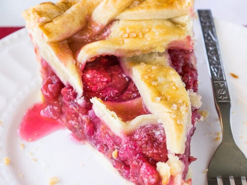 This homemade Raspberry Pie recipe is perfection! The filling is sweet and stays together, doesn't fall apart!