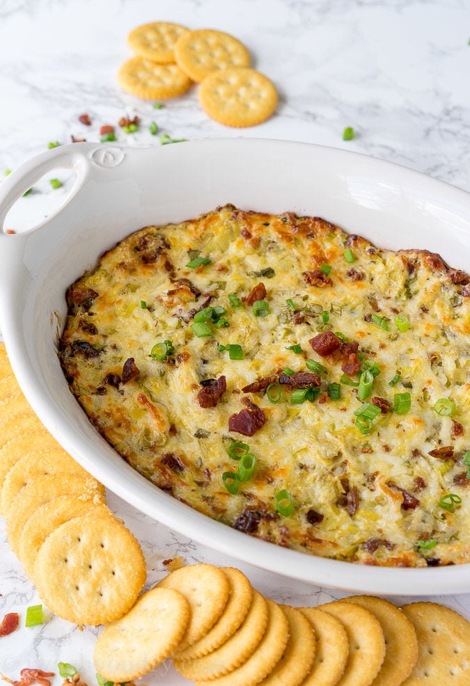 This Cheesy Bacon Artichoke Dip is just 5 ingredients and so easy to make! There are never any leftovers!