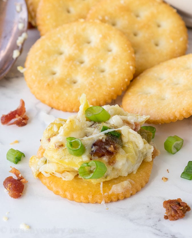 This Cheesy Bacon Artichoke Dip is just 5 ingredients and so easy to make! There are never any leftovers!