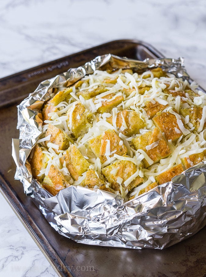 This Cheesy Pesto Crack Bread is a super quick and easy appetizer that everyone will go nuts for!