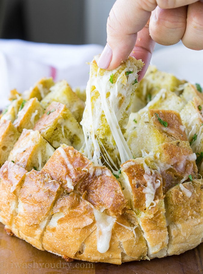 This Cheesy Pesto Crack Bread is a super quick and easy appetizer that everyone will go nuts for!