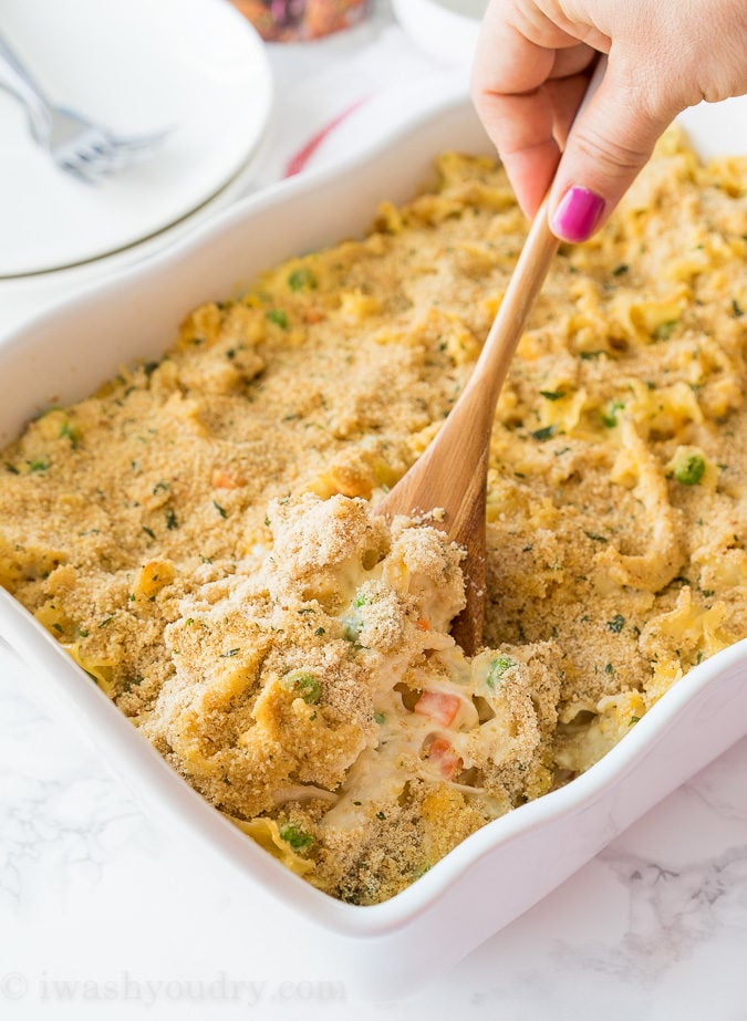 spoonful of chicken noodle dish with vegetables and crumb topping.