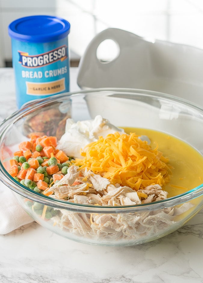 ingredients in large bowl with chicken and frozen vegetables