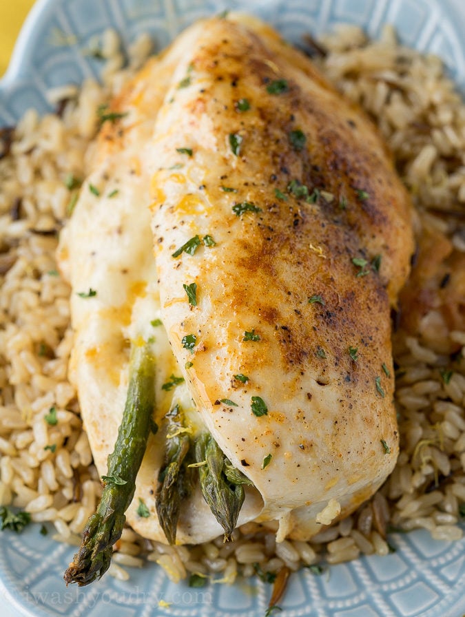 Quick Stuffed Chicken Breast on top of plate of rice.