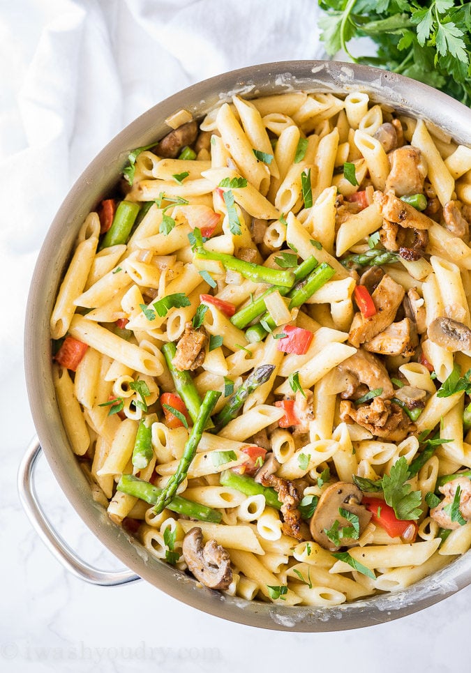chicken asparagus and pasta in pan with handles.