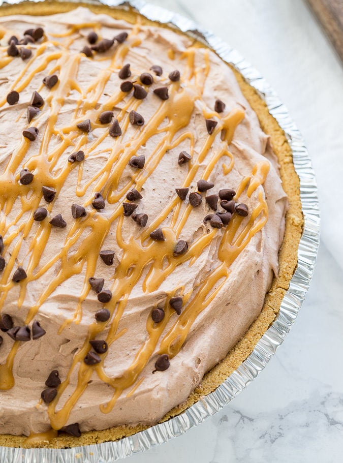 This Peanut Butter Chocolate Mousse Pie is a super simple dessert that comes together in minutes! We love the thick peanut butter ganache on the bottom combined with the light and fluffy chocolate mousse on top! Perfect combination.