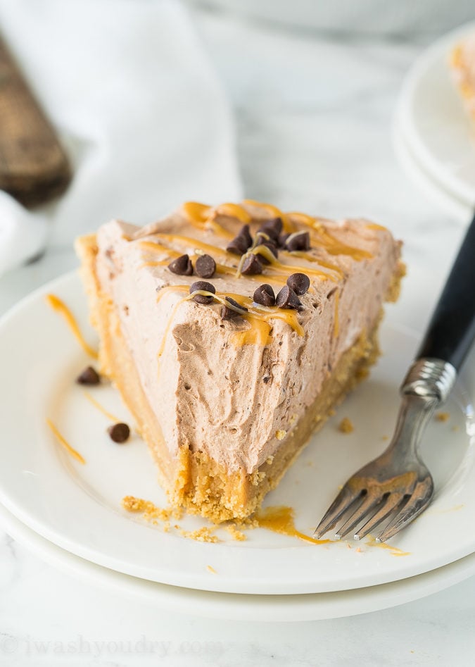 This Peanut Butter Chocolate Mousse Pie is a super simple dessert that comes together in minutes! We love the thick peanut butter ganache on the bottom combined with the light and fluffy chocolate mousse on top! Perfect combination.