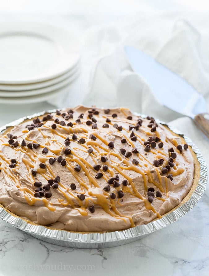This Peanut Butter Chocolate Mousse Pie is a super simple dessert that comes together in minutes! We love the thick peanut butter ganache on the bottom combined with the light and fluffy chocolate mousse on top! Perfect combination.