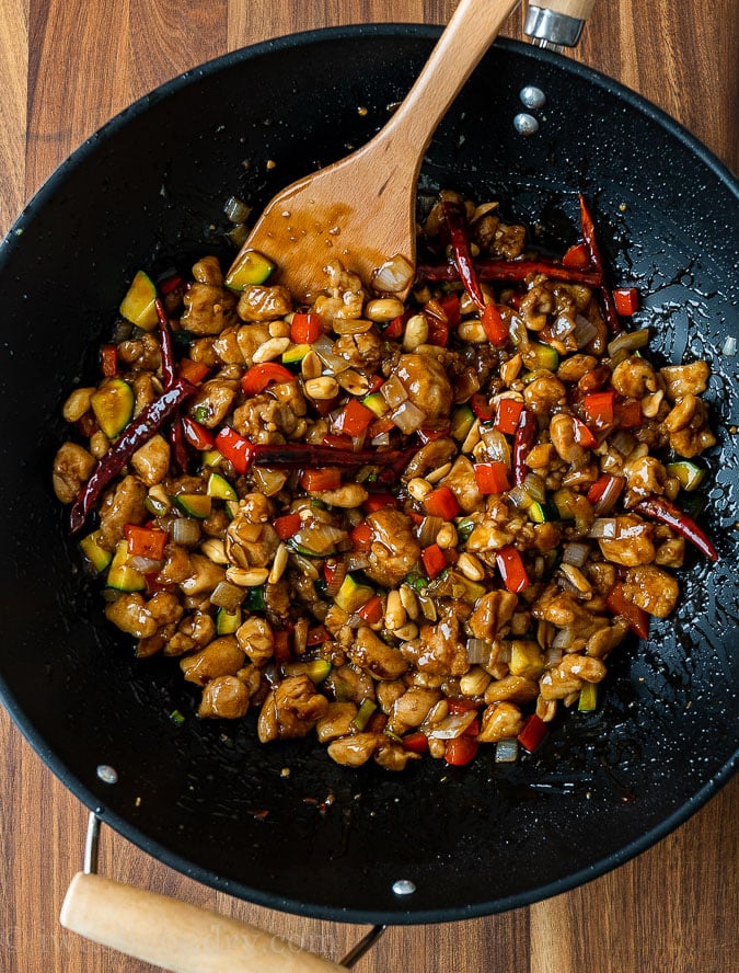 cooked chicken and vegetables in sauce with spoon