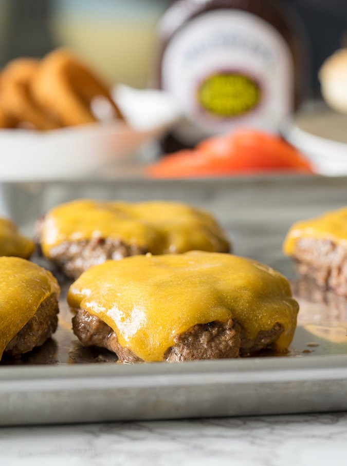 These Honey BBQ Cowboy Burgers are thick and juicy hamburger patties that are topped with cheese, Sweet Baby Ray's Honey BBQ Sauce and crispy onion rings. It's a party in your mouth!