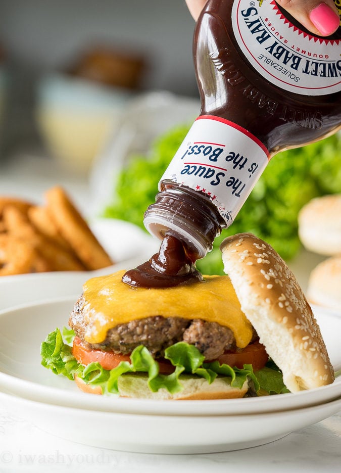 These Honey BBQ Cowboy Burgers are thick and juicy hamburger patties that are topped with cheese, Sweet Baby Ray's Honey BBQ Sauce and crispy onion rings. It's a party in your mouth!