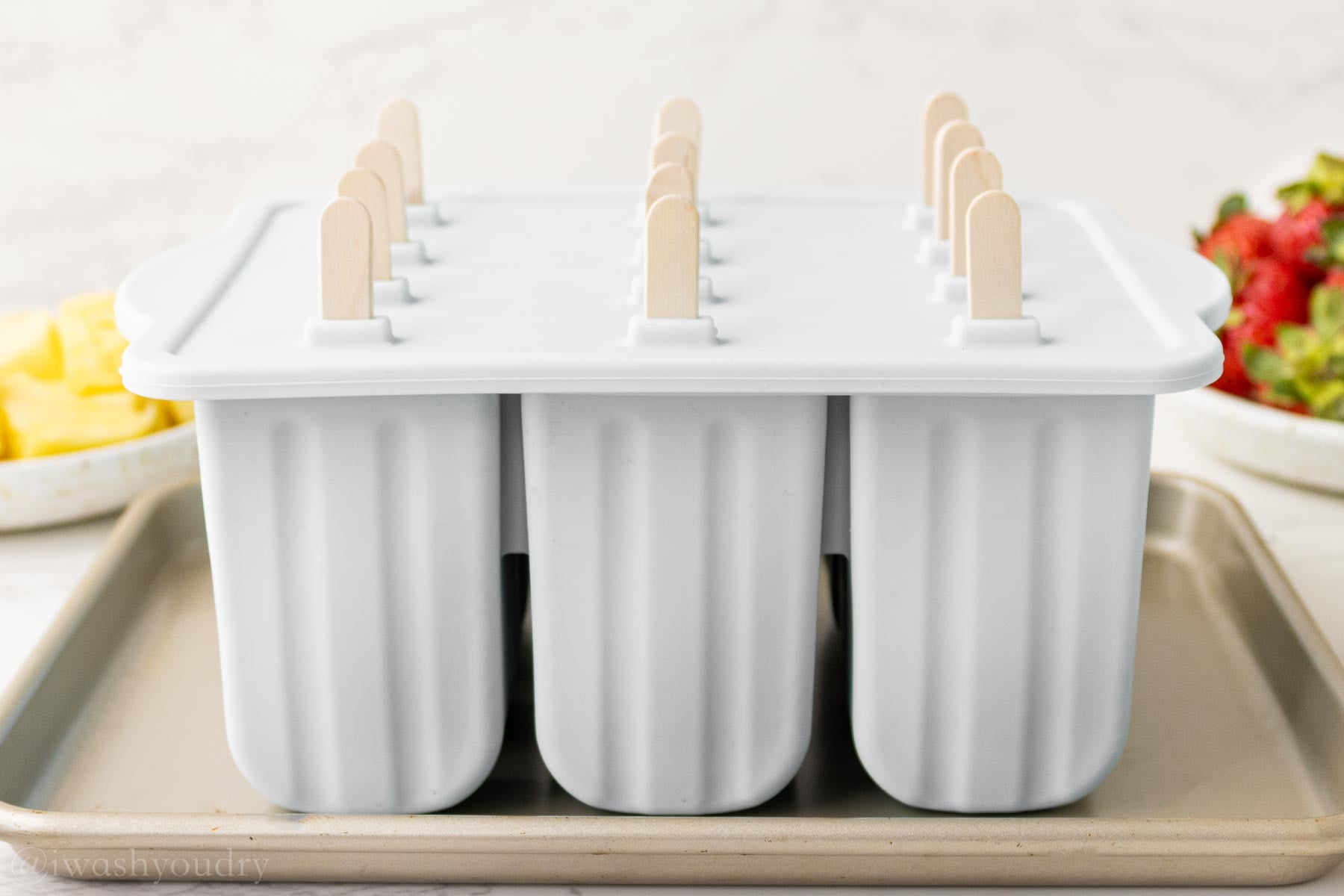 popsicles in popsicle mold with sticks inserted.
