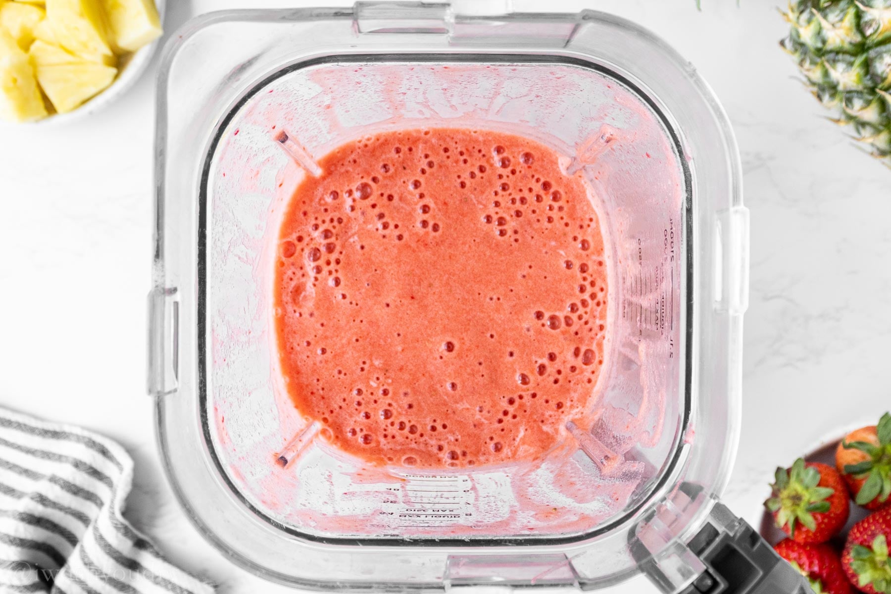 blended strawberries and pineapple in pureed form.